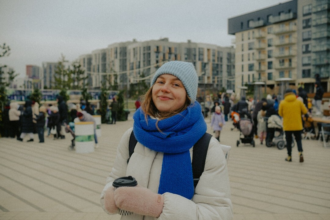 Smiling senior woman holding a membership card outdoors