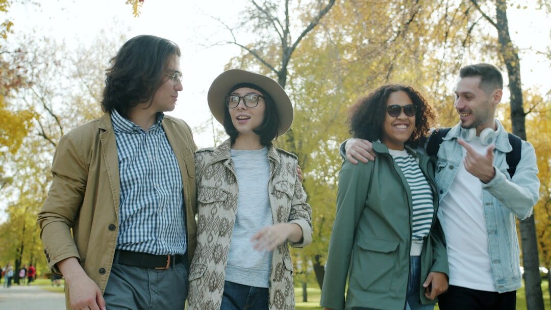 Group of smiling senior friends laughing together outdoors in a park